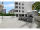 Resort-style community pool with barbecue area, outdoor seating and the building as the backdrop at 128 Golden Gate Pt # 501B, Sarasota, FL 34236
