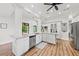Bright kitchen with granite counters, large island, stainless appliances, and access to the outdoor living space at 13331 Drysdale Ave, Port Charlotte, FL 33981