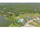 Aerial view of a community pool, lake, and winding river surrounded by lush greenery at 16916 Rosedown Gln, Parrish, FL 34219