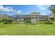 Spacious backyard with screened patio, pool, lush lawn, and landscaped borders offering serene outdoor living at 16916 Rosedown Gln, Parrish, FL 34219
