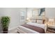Bedroom features neutral colors, large window with plantation shutters and decorative art at 16916 Rosedown Gln, Parrish, FL 34219