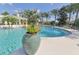 Community pool featuring a decorative planter and fountains, creating a relaxing environment at 16916 Rosedown Gln, Parrish, FL 34219