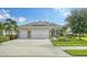 Charming single-story home featuring a three car garage and beautifully landscaped front yard at 16916 Rosedown Gln, Parrish, FL 34219