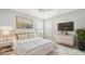 Bright main bedroom with a king bed, white bedding, modern furniture and ample natural light at 16916 Rosedown Gln, Parrish, FL 34219