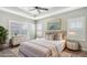 Comfortable main bedroom featuring tray ceilings, neutral tones, and large windows at 16916 Rosedown Gln, Parrish, FL 34219