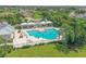 Aerial view of a community pool with resort-style seating and lush tropical landscaping at 16916 Rosedown Gln, Parrish, FL 34219