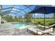 A tranquil pool with clear water, chaise lounges, and a serene view of the pond and landscaping at 16916 Rosedown Gln, Parrish, FL 34219