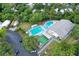An aerial view of the community pool and shuffleboard area with people enjoying themselves on a sunny day at 3333 26Th E Ave # 1230, Bradenton, FL 34208