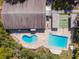 Aerial view of the community pool featuring a jacuzzi, lounge chairs, and a shuffleboard court at 3333 26Th E Ave # 1230, Bradenton, FL 34208