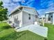 Exterior side view of a cozy home, with a concrete walkway and a vibrant blue sky at 3333 26Th E Ave # 1230, Bradenton, FL 34208