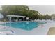 A clear view of the refreshing swimming pool, sun loungers, and a shaded seating area at 3333 26Th E Ave # 1230, Bradenton, FL 34208