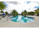 Relaxing pool area with palm trees and lounge chairs at 5712 Hevena Ct, Palmetto, FL 34221