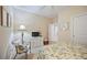 Bright bedroom with a floral-print bed and sitting area at 606 Riviera Dunes Way # 303, Palmetto, FL 34221