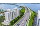 Aerial view of condo building near a bridge and water at 128 Golden Gate Pt # 501B, Sarasota, FL 34236