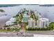 Aerial view of a waterfront community with a white building at 128 Golden Gate Pt # 501B, Sarasota, FL 34236