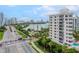 An aerial view of a white building near a roadway and other buildings at 128 Golden Gate Pt # 501B, Sarasota, FL 34236