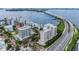 An aerial view showcasing a building near a bridge and water at 128 Golden Gate Pt # 501B, Sarasota, FL 34236