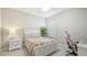 Cozy bedroom featuring a white bed frame and a workspace at 16916 Rosedown Gln, Parrish, FL 34219