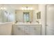 Double vanity bathroom with white cabinets and a shower at 16916 Rosedown Gln, Parrish, FL 34219