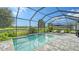 Relaxing screened-in pool and patio area with water feature, overlooking a tranquil landscape at 16916 Rosedown Gln, Parrish, FL 34219