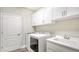 Laundry room with washer, dryer, cabinets, and utility sink at 16916 Rosedown Gln, Parrish, FL 34219