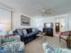 Cozy living room featuring a blue sofa, comfy armchairs, and a ceiling fan at 3333 26Th E Ave # 1230, Bradenton, FL 34208