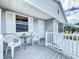 Covered porch with white railing, small table and chairs at 3333 26Th E Ave # 1230, Bradenton, FL 34208