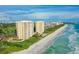 Aerial view of beachfront condos and shoreline at 603 Longboat Club Rd # 602N, Longboat Key, FL 34228