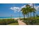 Brick walkway to beach with tropical landscaping at 603 Longboat Club Rd # 602N, Longboat Key, FL 34228