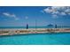 Refreshing community pool with ocean views and ample lounge chairs at 603 Longboat Club Rd # 602N, Longboat Key, FL 34228