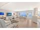 Bright living room with ocean views, hardwood floors, and modern furniture at 603 Longboat Club Rd # 602N, Longboat Key, FL 34228