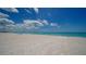 Peaceful beach view with a lone beach umbrella at 603 Longboat Club Rd # 602N, Longboat Key, FL 34228
