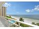 Balcony view of the beach, ocean, and pool below at 603 Longboat Club Rd # 602N, Longboat Key, FL 34228