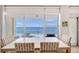 Elegant dining room with ocean view and modern table and chairs at 603 Longboat Club Rd # 602N, Longboat Key, FL 34228