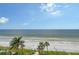 Aerial view of pristine beach with palm trees and ocean at 603 Longboat Club Rd # 602N, Longboat Key, FL 34228