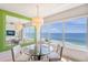Ocean view dining area with modern glass table at 603 Longboat Club Rd # 602N, Longboat Key, FL 34228