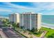 Aerial view of luxurious beachfront condo building with ocean views at 603 Longboat Club Rd # 602N, Longboat Key, FL 34228