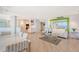 Open living area with ocean view, white sofa, and modern kitchen at 603 Longboat Club Rd # 602N, Longboat Key, FL 34228