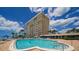 Resort-style pool with plenty of lounge chairs and ocean view at 603 Longboat Club Rd # 602N, Longboat Key, FL 34228