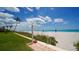 Beach access with outdoor shower; steps to the sand at 603 Longboat Club Rd # 602N, Longboat Key, FL 34228