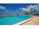 Inviting community pool with ocean views and ample lounge chairs at 603 Longboat Club Rd # 602N, Longboat Key, FL 34228