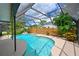 Inviting screened pool with a waterfall feature and ample surrounding space at 6933 9Th E Ct, Sarasota, FL 34243