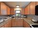 Kitchen with granite countertops and light wood cabinets at 6933 9Th E Ct, Sarasota, FL 34243