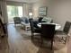 Living room and dining area with wood flooring, comfy seating, and a round dining table at 3600 Lake Bayshore Drive Bld. K # 221, Bradenton, FL 34205