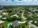 Stunning aerial view of a lush, green neighborhood with luxurious homes and a community pool at 1389 Harbor Dr, Sarasota, FL 34239
