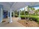 Charming front porch with white columns, lush landscaping and brick pavers at 1389 Harbor Dr, Sarasota, FL 34239