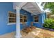 Charming covered outdoor patio with rocking chairs and a pillar, perfect for relaxing outdoors at 1389 Harbor Dr, Sarasota, FL 34239