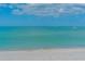 Tranquil beach scene featuring calm, inviting waters with people enjoying the ocean at 4995 Pepperwood Pl, Venice, FL 34293