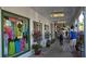 Shops line a sidewalk, with lush plants and people walking along, creating an inviting, walkable atmosphere at 4995 Pepperwood Pl, Venice, FL 34293
