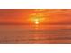 Golden sunset over the ocean, reflecting warmth and tranquility, emphasizing the serene coastal living experience at 4995 Pepperwood Pl, Venice, FL 34293